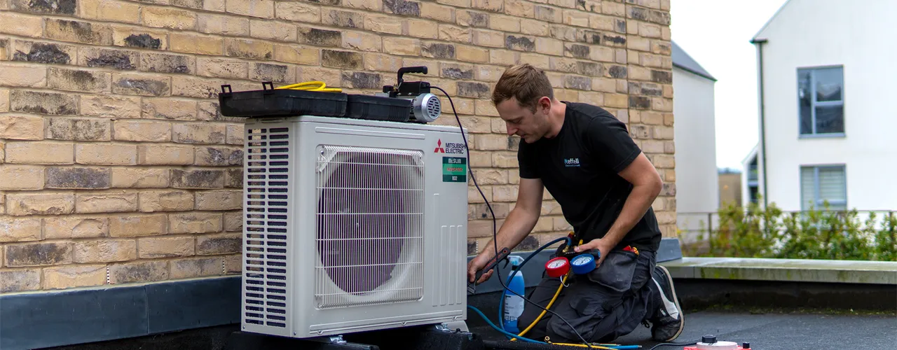 Aircon Engineer On Roof Installing Aircon