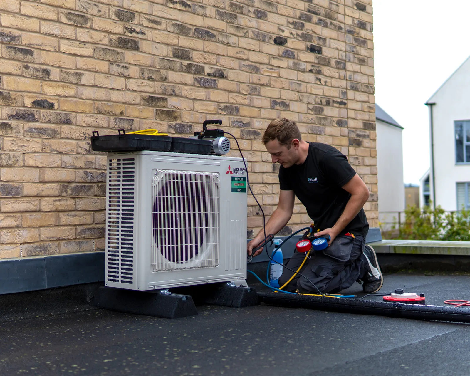 Aircon Engineer On Roof Installing Aircon