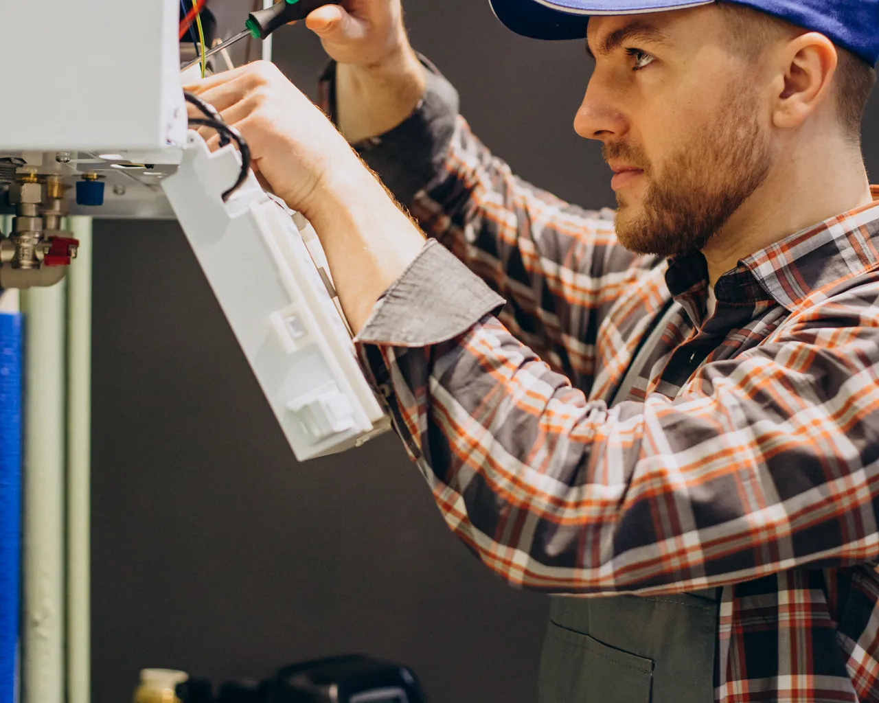 Service Man Adjusting House Heating System