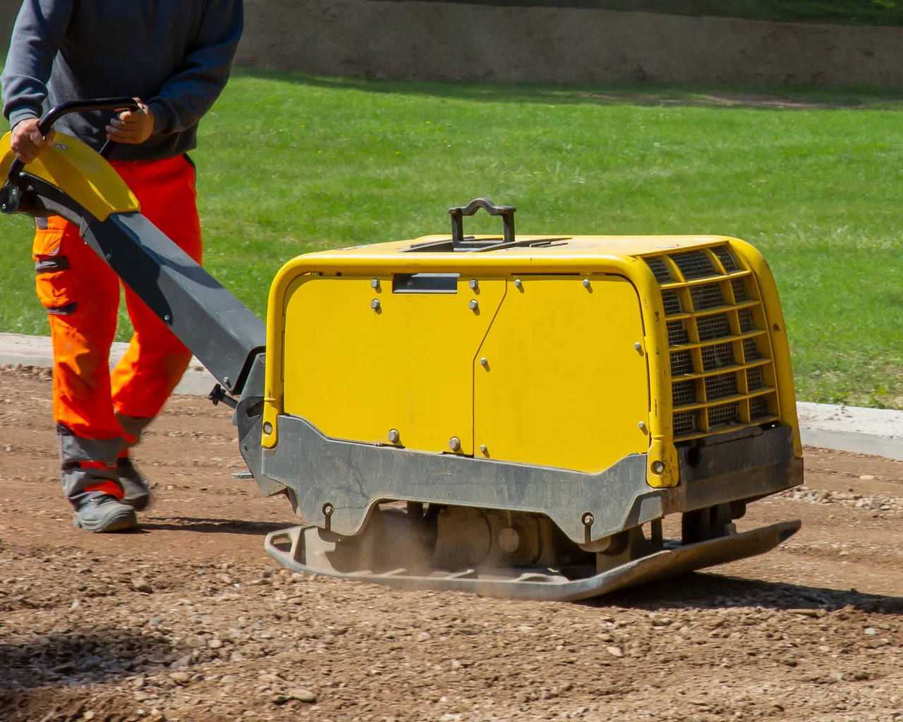 Worker Flattening Ground