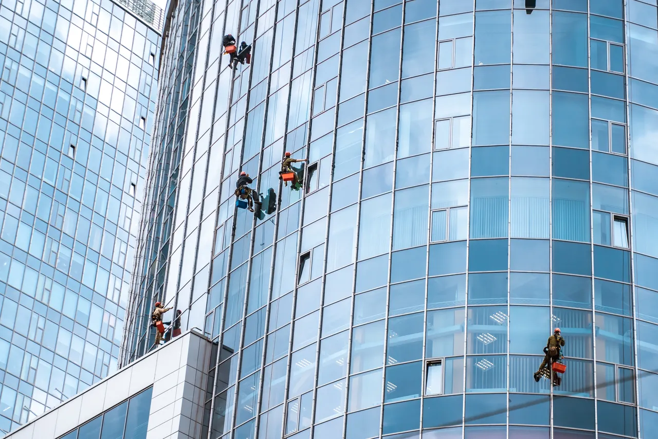 Workers Washing Windows Office Building
