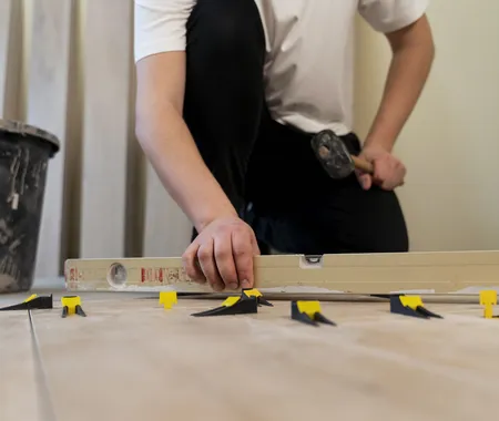 Low Angle Man Tiling Floor