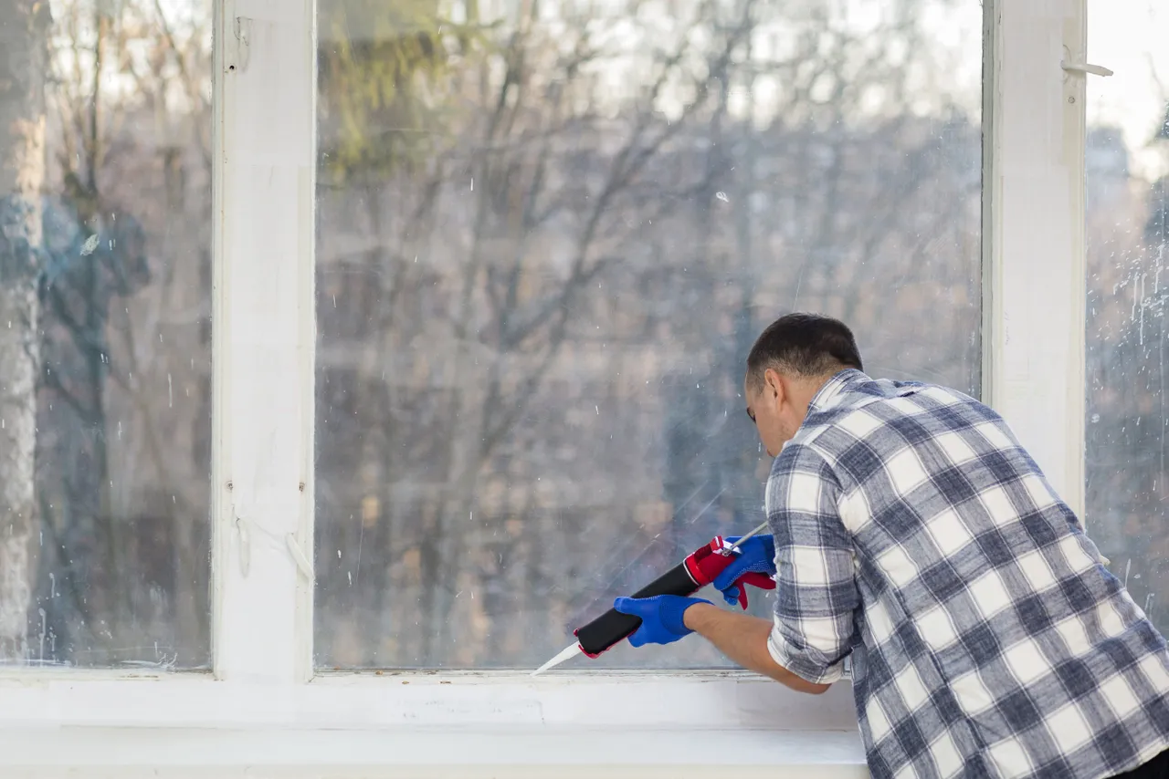 Man Putting Silicone On Window