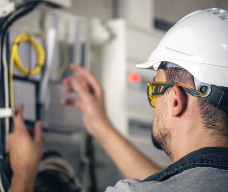 Man Electrical Technician Working Switchboard With Fuses