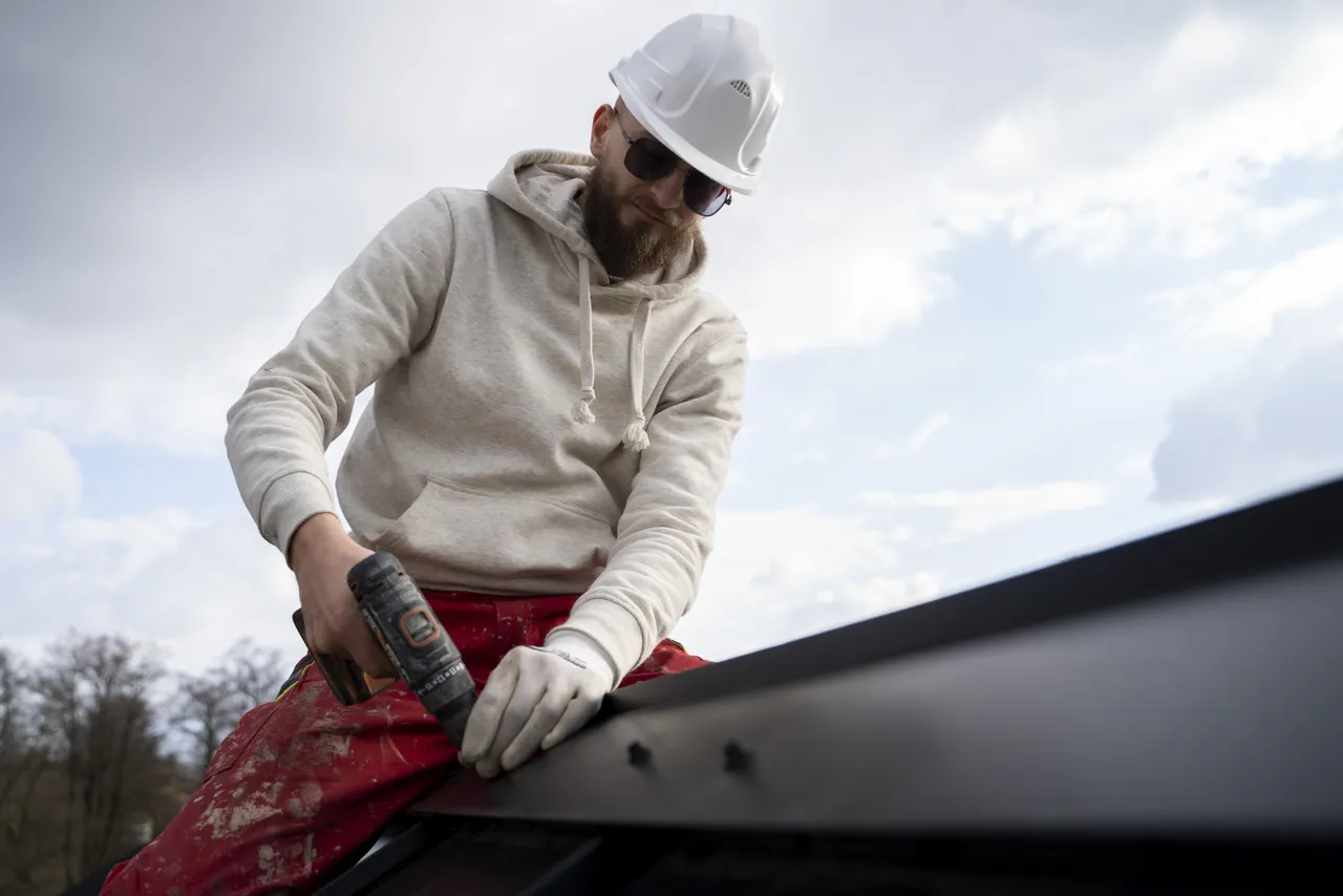 Man Working With Protection Helmet On Roof