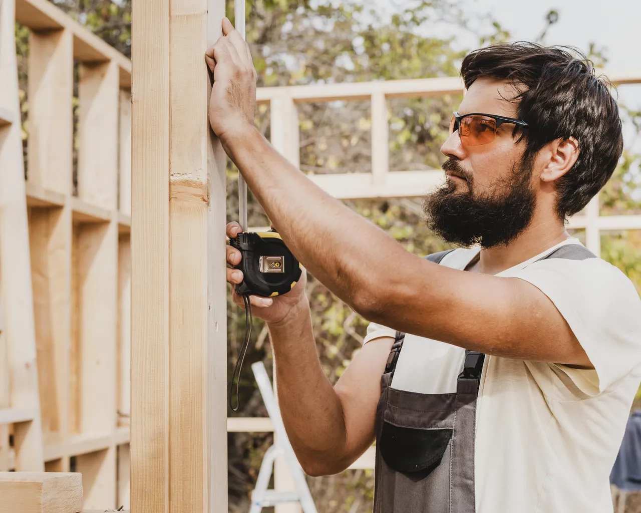 Carpenter Man Using Tape Measure