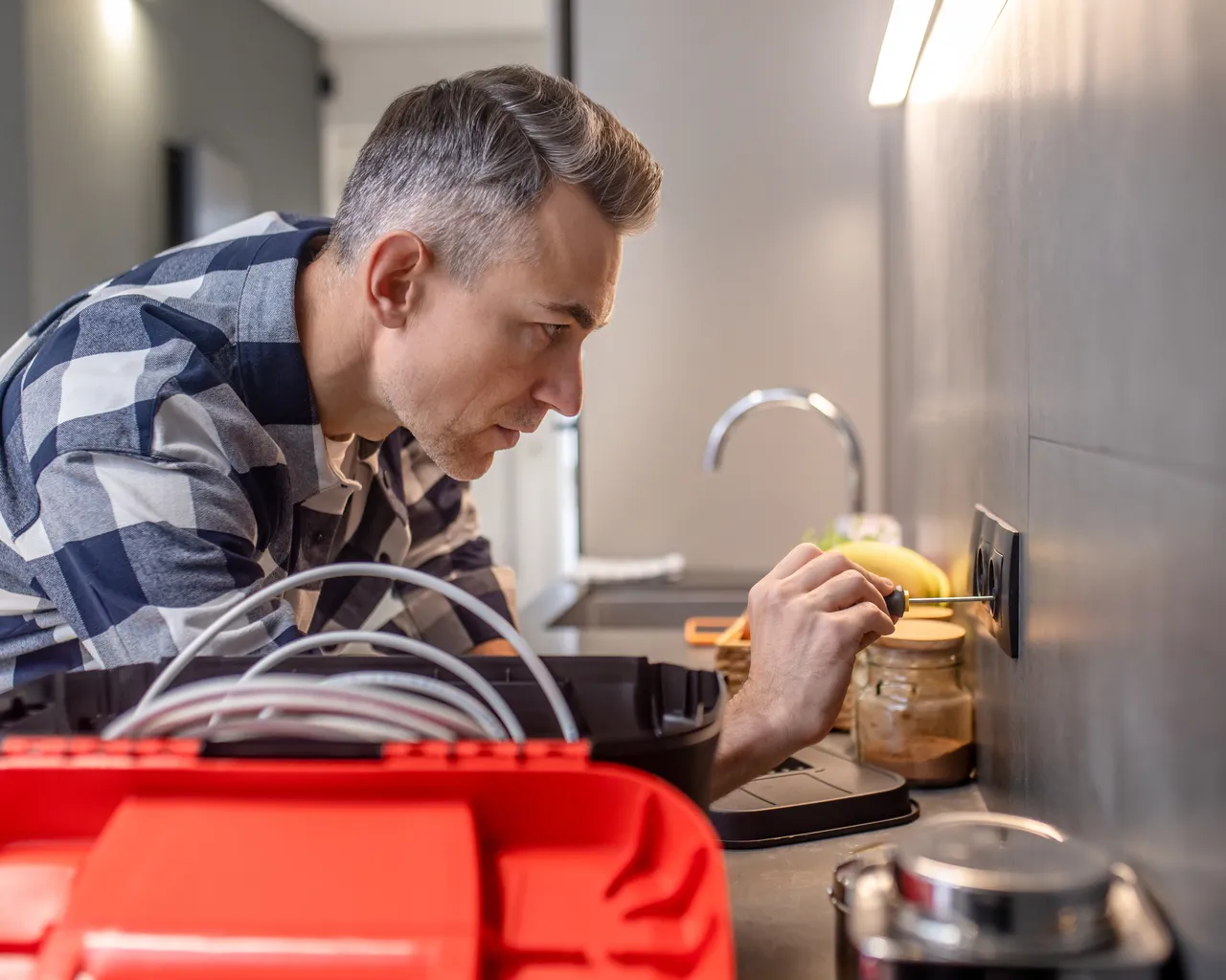 Profile Man Touching Socket Wall With Screwdriver