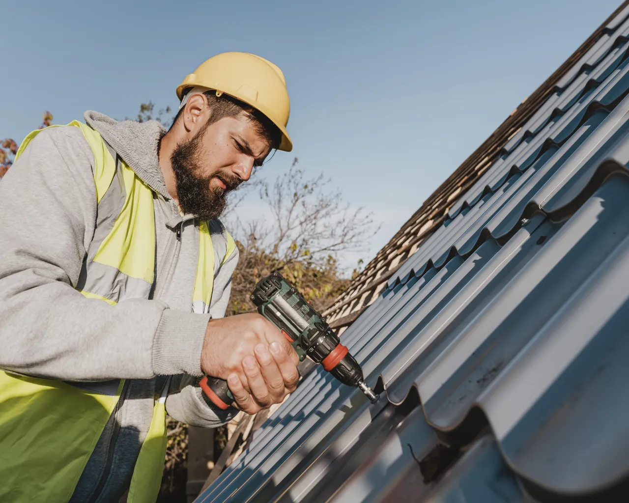 Man Working Roof With Drill