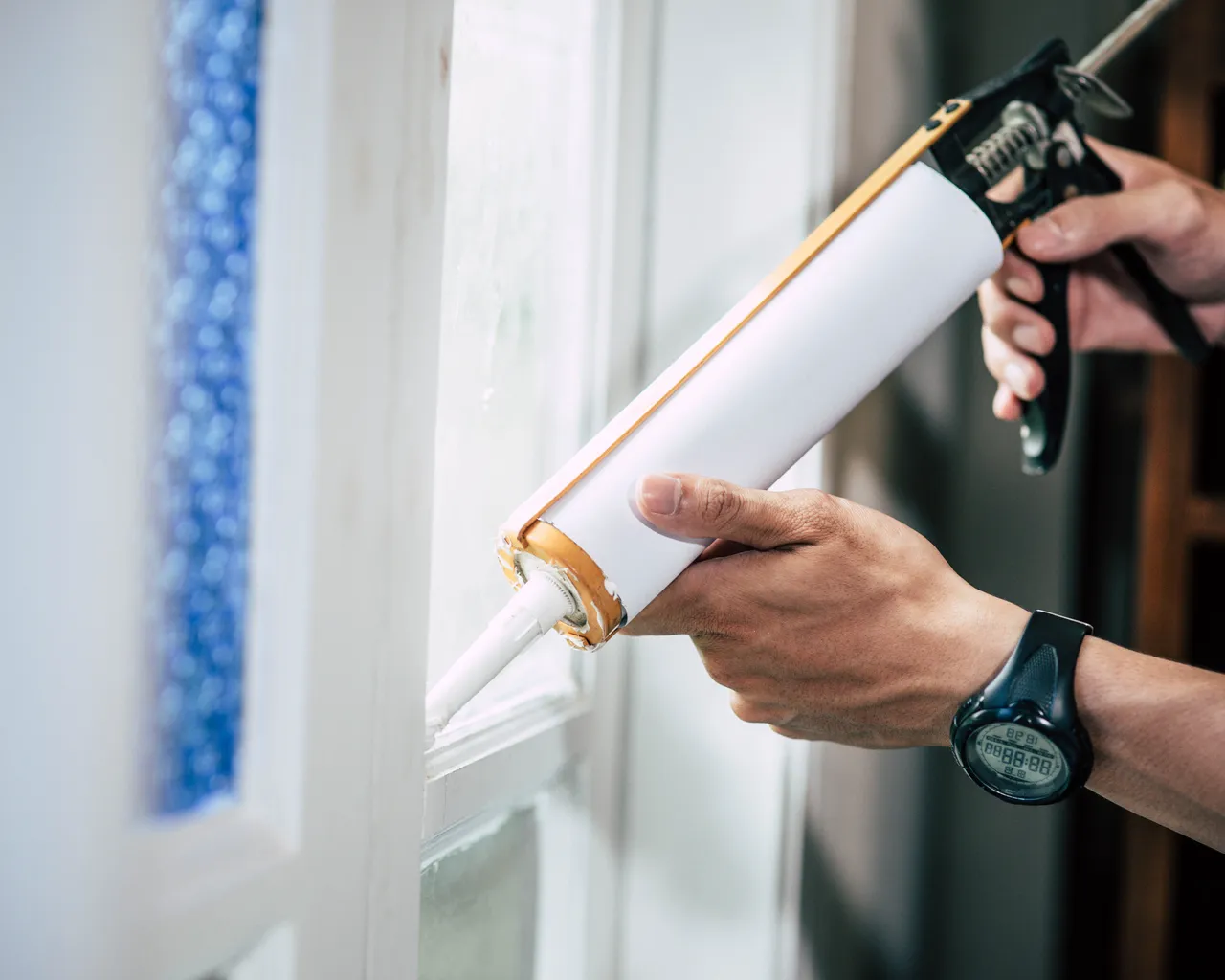 Carpenter Holds Glue Attaches Window