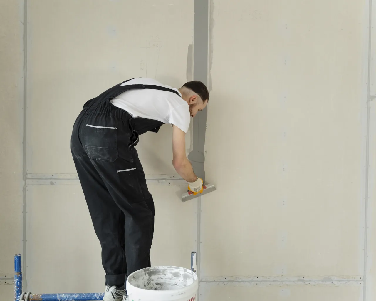 Worker Using Plastering Trowel